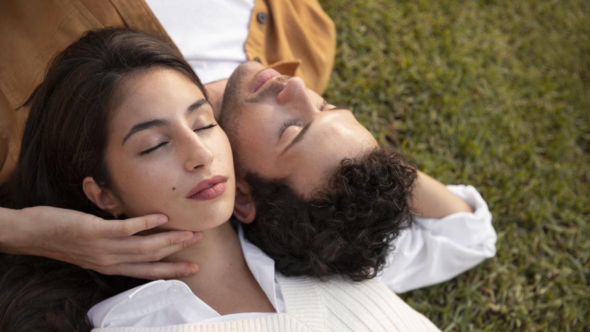 close-up-couple-sleeping-grass-1200-675 Young couple breathing gently whilst lying on the grass together.